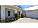 Exterior view of a white two-story house with white columns and landscaping at 28992 Gin Ln, Punta Gorda, FL 33982