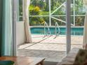 Inviting pool area with a screened enclosure at 1191 Manor Rd, Englewood, FL 34223