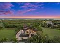 Luxury waterfront home with landscaped grounds and sunset view at 21321 Harborside Blvd, Port Charlotte, FL 33952