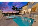 Luxury pool and spa with travertine decking and sunset view at 21321 Harborside Blvd, Port Charlotte, FL 33952