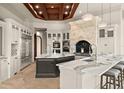 Gourmet kitchen boasts a wood-coffered ceiling, stone range hood, double islands, and stainless steel appliances at 21321 Harborside Blvd, Port Charlotte, FL 33952