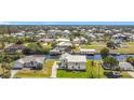 Home with canal access, boat dock, and lush green lawn at 24313 Pirate Harbor Blvd, Punta Gorda, FL 33955