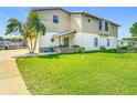 Well-maintained, two-story home with lush green lawn and inviting curb appeal at 24313 Pirate Harbor Blvd, Punta Gorda, FL 33955