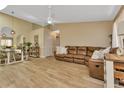 Spacious living room with a brown leather sectional sofa and wood-look tile floors at 3300 Loveland Blvd # 1301, Punta Gorda, FL 33980