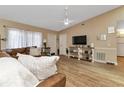 Living room with hardwood floors, brown leather couch, and built-in shelving at 3300 Loveland Blvd # 1301, Punta Gorda, FL 33980
