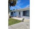 White single story home with gray door and landscaping at 1286 Hillcrest Nw Ave, Port Charlotte, FL 33948