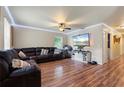 Living Room with L-shaped sectional sofa, hardwood floors, and large TV at 265 Tipton St, Port Charlotte, FL 33954