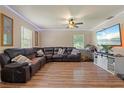Spacious living room with L-shaped sectional sofa and hardwood floors at 265 Tipton St, Port Charlotte, FL 33954