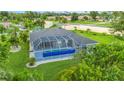 Aerial view showcasing a home with a pool and lush landscaping at 5001 Richmond Ter, North Port, FL 34287