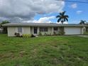 Single-story home with attached garage and landscaped lawn at 24239 Yacht Club Blvd, Punta Gorda, FL 33955