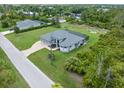 Aerial view showcasing a single-Gathering home with a large yard at 14041 Clarissa Ln, Port Charlotte, FL 33981