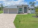 Single-Gathering home with three-car garage and attractive landscaping at 14041 Clarissa Ln, Port Charlotte, FL 33981