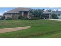 One story house with mature landscaping and a large yard at 7100 Mineola Rd, Englewood, FL 34224