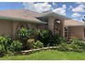 One-story house with a landscaped yard and arched entryway at 7100 Mineola Rd, Englewood, FL 34224