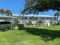 Condo building with covered parking and tropical landscaping at 26470 Rampart Blvd # 123, Punta Gorda, FL 33983