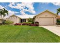 Single story home with metal roof and landscaped lawn at 3621 Whippoorwill Blvd, Punta Gorda, FL 33950