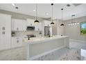 A gourmet kitchen with marble countertops, stainless steel appliances, and a large center island at 212 Fairway Rd, Rotonda West, FL 33947