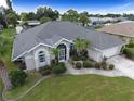 Stunning home boasting an arched entryway and a lush, green landscaped front yard at 515 Allworthy St, Port Charlotte, FL 33954