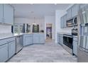 Modern kitchen with gray cabinets and stainless steel appliances at 47 Mariner Ln, Rotonda West, FL 33947