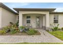 Exterior view showing the front entrance with a covered porch and landscaped walkway at 16195 Maya Cir, Punta Gorda, FL 33955