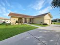 Front view of a single-story house with a two-car garage at 695 Coronado Dr, Punta Gorda, FL 33950