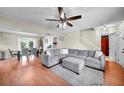 Living room with gray sectional sofa and hardwood floors at 11994 Xavier Ave, Port Charlotte, FL 33981