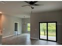 Bright living room featuring tile floors and sliding glass doors at 13460 Tolman Ave, Port Charlotte, FL 33953
