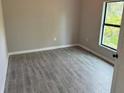Spacious bedroom with tile floors and large window at 13460 Tolman Ave, Port Charlotte, FL 33953