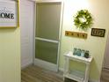 Light and bright entryway with door, hall tree, and 'welcome home' decor at 25275 Rampart Blvd # 2001, Punta Gorda, FL 33983