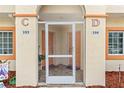 Shared entryway to units 103 and 104 with screened doors at 1186 Rio De Janeiro Ave # 104, Punta Gorda, FL 33983