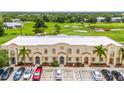 Aerial view of a multi unit building complex near a golf course and lake at 1186 Rio De Janeiro Ave # 104, Punta Gorda, FL 33983