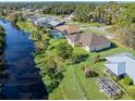 Waterfront property with a canal view and neighboring homes at 1516 Natrona Dr, North Port, FL 34286