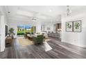 Bright living room with an open floor plan, stylish furnishings and access to the backyard at 16077 Coruna Ct, Punta Gorda, FL 33955