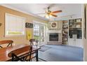 Bright breakfast nook featuring a brick fireplace, built-in shelving, and french doors to the yard at 23117 Hillsdale Ave, Port Charlotte, FL 33954