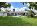 House exterior with patio furniture and spacious backyard at 23117 Hillsdale Ave, Port Charlotte, FL 33954