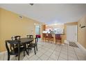 Condo dining area with a table and chairs, kitchen and living room view at 25050 Sandhill Blvd # A4 Bldg 2, Punta Gorda, FL 33983