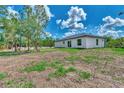 Rear view of a newly built home with gray siding at 4637 Corbett Ln, North Port, FL 34288