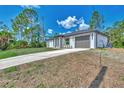 Single-story home with attached garage and driveway at 4637 Corbett Ln, North Port, FL 34288