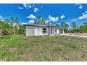 Newly built home with gray siding and a two-car garage at 4637 Corbett Ln, North Port, FL 34288