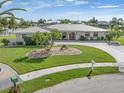 Single-Gathering home on a waterfront lot with palm trees and manicured lawn at 374 Severin Se Rd, Port Charlotte, FL 33952