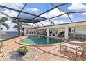 Relaxing kidney-shaped pool with brick patio and covered lanai at 374 Severin Se Rd, Port Charlotte, FL 33952