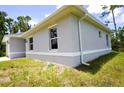 Exterior side view showcases the home's design, with white trim and a well-kept lawn at 2163 Blaser St, Punta Gorda, FL 33980