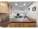 Open concept living room with a ceiling fan, large window, and casual decor at 22375 Edgewater Dr # 126, Port Charlotte, FL 33980