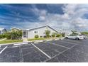 Exterior of villa showing parking spaces and landscaping at 3300 Loveland Boulevard # 1904, Port Charlotte, FL 33980