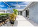 Screened patio with tile flooring and potted plants at 3300 Loveland Boulevard # 1904, Port Charlotte, FL 33980
