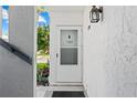 Condo entryway with white door and surrounding building exterior at 22375 Edgewater Dr # 126, Port Charlotte, FL 33980