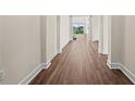 Long hallway with wood-look flooring leading to other rooms at 42548 Little Ridge Rd, Punta Gorda, FL 33982