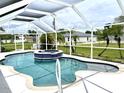 Inviting swimming pool with spa and screened enclosure at 530 Kensington St, Port Charlotte, FL 33954