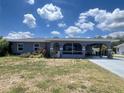 Inviting single-Gathering home featuring a covered carport, screened porch, and a pleasant front yard at 1405 Dorchester St, Port Charlotte, FL 33952