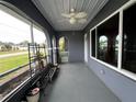 Inviting front porch features an outdoor ceiling fan and room for seating at 1405 Dorchester St, Port Charlotte, FL 33952